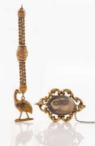 An antique mourning brooch in pinchbeck mount, together with an antique Albertina fob chain (unmarked) with gold plated emu fob, 19th century, the brooch 4.9cm wide