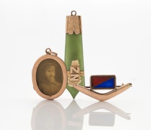 WILLIS & SONS of Melbourne WW1 period 9ct rose gold boomerang brooch with field artillery enamel colours, together with a WILLIS & SONS 9ct rose gold oval photo pendant with WW1 period portrait, plus an antique gold mounted New Zealand greenstone pendant, (3 items), the pendant 5.5cm high