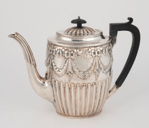 An antique sterling silver teapot with gadrooned decoration and repousse swags, made in Sheffield, circa 1884, 19cm high, 626 grams