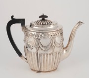 An antique sterling silver teapot with gadrooned decoration and repousse swags, made in Sheffield, circa 1884, 19cm high, 626 grams - 2