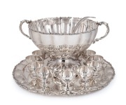 An impressive Continental 925 Sterling silver punch set comprising of a tray, two-handled punch bowl, ladle, and 12 cups. 20th century, the tray 55cm diameter, 7382 grams