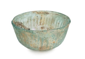 A Roman glass bowl with ribbed decoration, 1st-2nd century A.D., 5.5cm high, 12cm wide