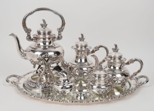 A vintage German 925 sterling silver tea service comprising of a spirit kettle, tea pot, hot water pot, milk jug, and sugar bowl; together with an attractive silver-plated serving tray. 20th century, (six items), stamped "Original Alt-Heidelberg, 925 Sterling Silver", the spirit kettle 35cm high, 3528 grams silver (not including tray)