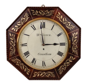 An antique English wall clock in octagonal mahogany case inlaid with brass, single train fusee movement with Roman numerals and convex glass, dial marked "Wm. GREEN, GRANTHAM", 19th century, 45cm high