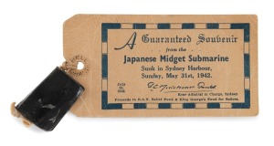 JAPANESE MINIATURE SUBMARINE metal fragment with affixed souvenir card "A Guaranteed Souvenir From The Japanese Midget Submarine. Sunk In Sydney Harbour, Sunday, May 31st, 1942", 4cm wide