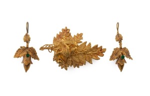 An antique 18ct yellow gold demi-parure brooch adorned with a bird, engraved "HOPE", together with a pair of earrings, set with green stones, circa 1870, the brooch 4cm wide, 4.3 grams total