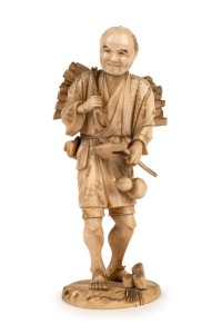 A fine quality antique Japanese carved ivory Okimono of a woodcutter, Meiji Period, red seal mark to base, 23cm high