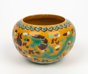 An antique Chinese porcelain alms bowl with green dragon decoration on yellow ground, Qing Dynasty, impressed six character mark to base, ​​​​​​​8cm high, 13cm diameter