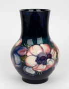 MOORCROFT "Anemone" pattern English pottery vase on blue and green ground, impressed signature mark "W. Moorcroft. Potter To H. M. The Queen. Made In England", 22cm high - 2
