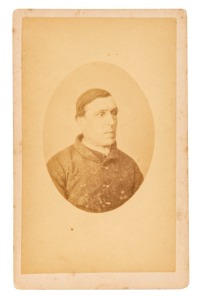 TASMANIAN CONVICT PHOTOGRAPH: A carte-de-visite, annotated verso: "28. Alexander Woods, per London. Taken at Port Arthur 1874". Alexander Wood was one of 250 convicts transported onboard the "London", arriving in Van Diemen's Land on 9th July 1844. He had been convicted and court martialled at St. Johns, Newfoundland, and sentenced to 14 years transportation. The prison photograph was taken 30 years after his arrival.
