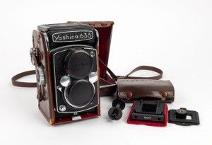 YASHICA: Yashica 635 TLR camera [#ST3120154], c. 1958, with Yashikor 80mm f3.5 lens, lens cap, leather case, and 35mm conversion kit. (2 items)