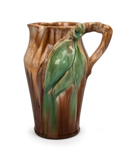 REMUED brown and green glazed pottery jug with applied gumnuts, leaves and branch handle, incised "Remued, Hand Made, 54/81", 22cm high