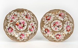 A pair of antique English porcelain plates with hand-painted floral vignettes and gilt decoration, circa 1830, 19.5cm wide