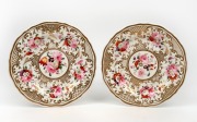 A pair of antique English porcelain plates with hand-painted floral vignettes and gilt decoration, circa 1830, 19.5cm wide