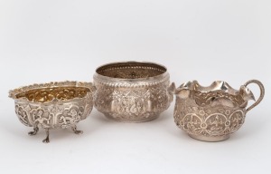 A Laotian repoussé silver bowl; together with a milk jug and sugar basin, 20th century, (3 items), the jug 14.5cm wide, 360 grams total