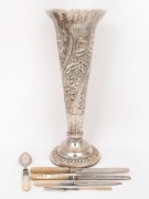 An antique silver plated trumpet vase with floral decoration; together with three sterling silver and shell handle knives, a sterling silver and shell handle jam spoon and a sterling silver and shell handle pickle fork, 19th/20th century, (6 items), the v