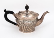An antique English sterling silver teapot with timber handle and finial, 15cm high, 400 grams including handle