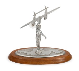Trench Art: Lockheed P-38 Lightning mounted on stand depicting Papua New Guinea, aluminium, c. 1940s, 26.5cm high and 21cm wingtip to wingtip.