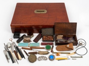 An antique timber box fitted with compartments containing assorted knives, scalpels, inkwell, sovereign case, buckle, jewellery, gold scales etc., 19th and 20th century, (qty), the box 43cm wide