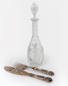 A pair of antique engraved silver fish servers, together with a crystal wine decanter, 19th and 20th century, the decanter 39cm high