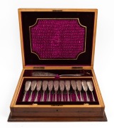 An antique silver plated fish cutlery set for twelve with engraved decoration and server, housed in a walnut canteen, 19th century, ​​​​​​​the canteen 46cm wide