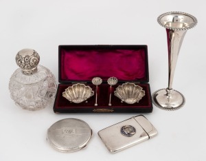 Sterling silver topped crystal vanity bottle, sterling silver trumpet vase with weighted base, silver powder compact and boxed salt cellars, all bearing Chester hallmarks; together with a Royal Artillery Company silver and enamel calling card case, 19th and 20th century, (5 items), the vase 15.5cm high