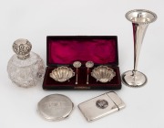 Sterling silver topped crystal vanity bottle, sterling silver trumpet vase with weighted base, silver powder compact and&nbsp;boxed salt cellars, all bearing Chester hallmarks; together with&nbsp;a Royal Artillery Company&nbsp;silver and enamel calling card case, 19th a