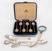 A boxed set of six English sterling silver teaspoons, a silver handled button hook, a silver and mother of pearl magnifying glass, a sterling silver seal top spoon, two antique sterling silver teaspoons and a silver plated caddy spoon, 19th and 20th centu