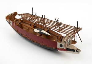 An outrigger model canoe, carved wood with hand-painted finish, Pacific Islands origin, 20th century, 51cm long