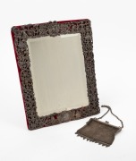 An antique English sterling silver mesh purse, together with an antique silver plated table mirror, 19th/20th century, (2 items), the mirror 31cm high, the purse 85 grams