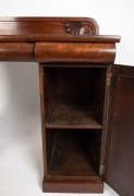 An antique Australian Colonial cedar twin pedestal sideboard in the classical manner, with recessed arch panels to the pedestals, crossbanded inserts, inverted break front top with three cushion moulded drawers and low back with scroll carving Athenian de - 3