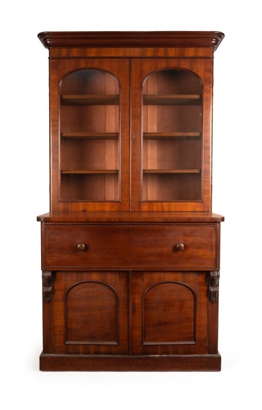 An antique Colonial secretaire, handsomely crafted with ribbon grain selected cedar with crossbanding and carved corbels, beautifully fitted with drawers and compartments in birdseye huon pine, with whalebone handles and ebonised trim, Melbourne origin, c