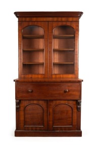 An antique Colonial secretaire, handsomely crafted with ribbon grain selected cedar with crossbanding and carved corbels, beautifully fitted with drawers and compartments in birdseye huon pine, with whalebone handles and ebonised trim, Melbourne origin, circa 1860, 228cm high, 122cm wide, 58cm deep