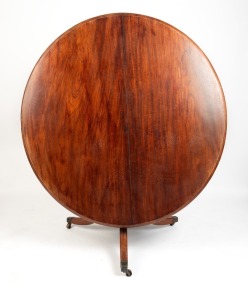 A Colonial Australian cedar tilt-top circular supper table with acanthus carved column, outward swept legs, and square form brass capped castors, two plank top with thumbnail edge, Tasmanian origin, circa 1830s. Note: Originally a fixed top table which has been converted to a tilt-top example at some stage in the 19th century which was the fashion at the time. 77cm high, 132cm diameter