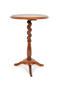 An unusual antique Australian mixed timber wine table with kauri pine top, blackwood barley twist column, huon pine base and blackwood feet, Tasmanian origin, 19th century, 66cm high, 44cm diameter