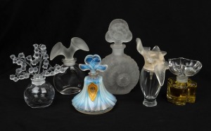 Six assorted perfume bottles with decorative stoppers, including examples by LALIQUE, the largest 15cm high