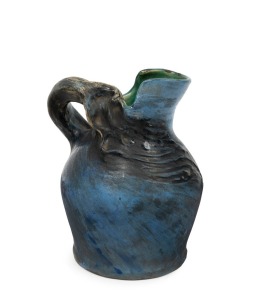 PHILLIPPA JAMES blue glazed pottery jug with windswept tree decoration, incised "Philippa James", 15.5cm high