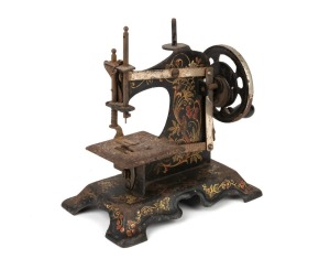 An antique miniature sewing machine with hand-painted finish, 19th/20th century, 16cm high