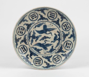 A Chinese blue and white porcelain dish with phoenix and cloud decoration, 19th/20th century, six character Ming mark to base, ​​​​​​​20.5cm diameter