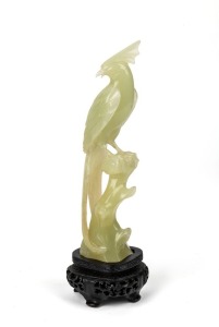 A Chinese carved jade bird ornament on carved timber stand, 20th century, housed in a fitted silk lined box, ​​​​​​​20.5cm high overall