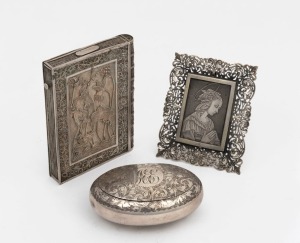 An antique filigree silver calling card case, together with an antique oval sterling silver box, and an attractive engraved silver religious plaque, 19th and 20th century, (3 items), the card case10cm high, 172 grams total