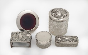 Three assorted antique silver topped vanity jars, a sterling silver circular picture frame, and a sterling silver oversized matchbox holder, 19th/20th century, (5 items), the largest jar 9cm high