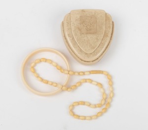 A vintage ivory bangle, and an ivory bead necklace, early 20th century, the necklace 45cm long