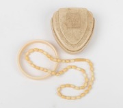 A vintage ivory bangle, and an ivory bead necklace, early 20th century, the necklace 45cm long