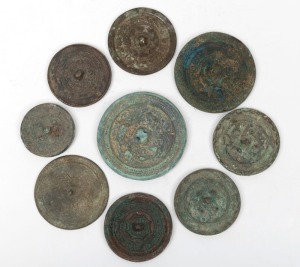 Nine assorted archaic style bronze and steel circular mirrors, unknown age, the largest 9cm diameter