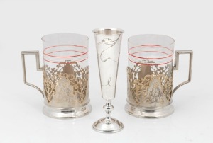 A pair of Russian silver tea glass holders; together with a Russian silver vodka goblet with engraved floral decoration, 19th/20th century, (3 items), the vodka cup 14cm high, silver weight 228 grams