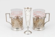A pair of Russian silver tea glass holders; together with a Russian silver vodka goblet with engraved floral decoration, 19th/20th century, (3 items), the vodka cup 14cm high, silver weight 228 grams