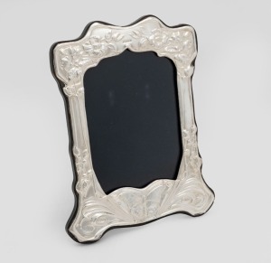 An English sterling silver picture frame crafted in the Art Nouveau style with flowers and butterfly decoration, 20cm high