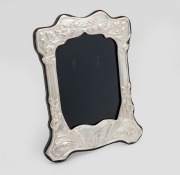 An English sterling silver picture frame crafted in the Art Nouveau&nbsp;style with flowers and butterfly decoration, 20cm high