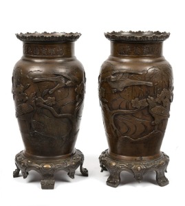 A pair of antique Chinese bronze mantle urns adorned with birds and blossoms, 19th century, 31cm high